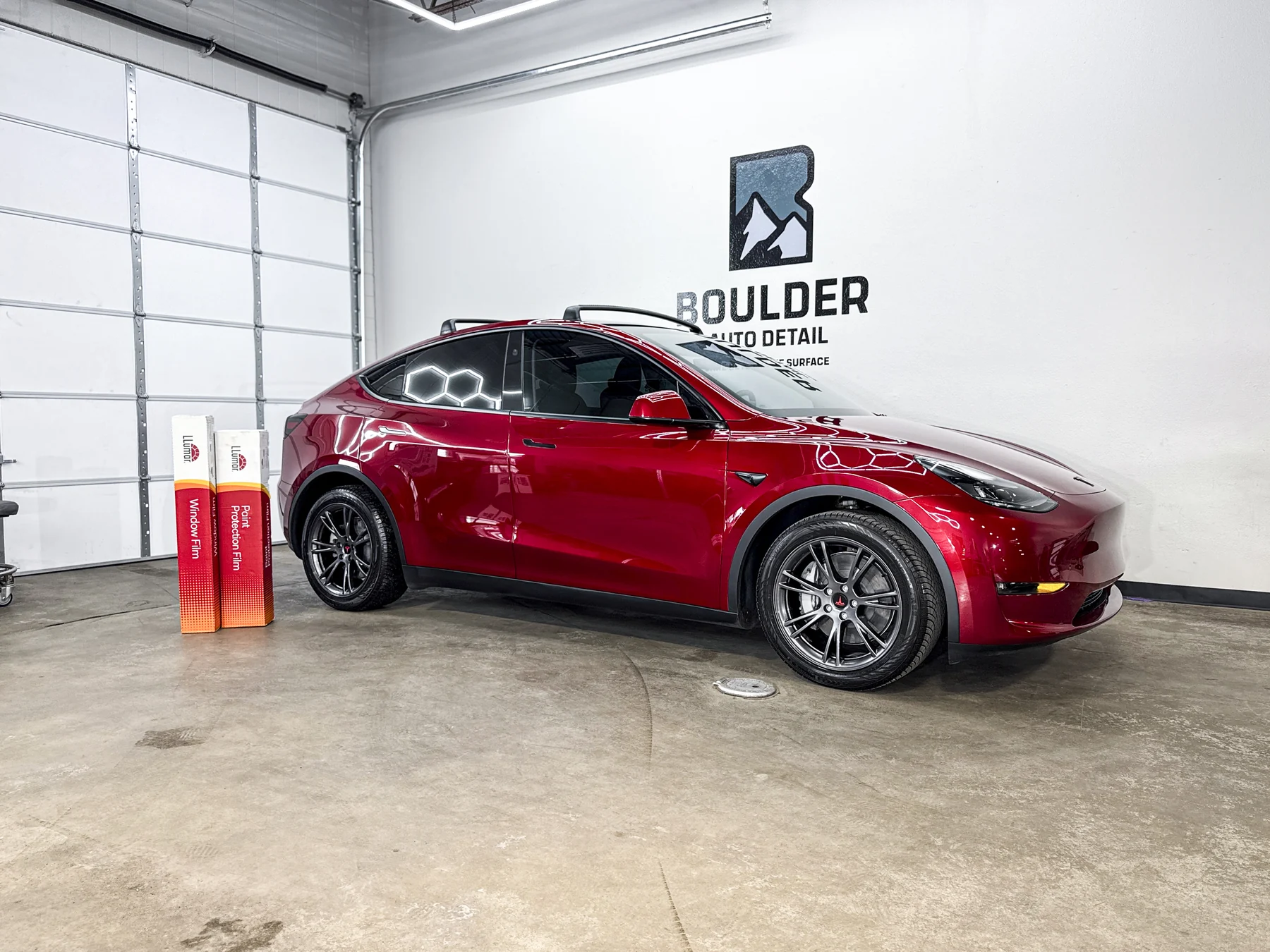 Red sedan photographed inside Boulder Auto Detail
