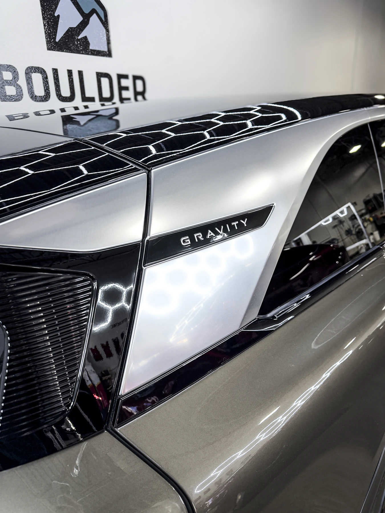 Lucid Gravity badge and reflective front bodywork detail
