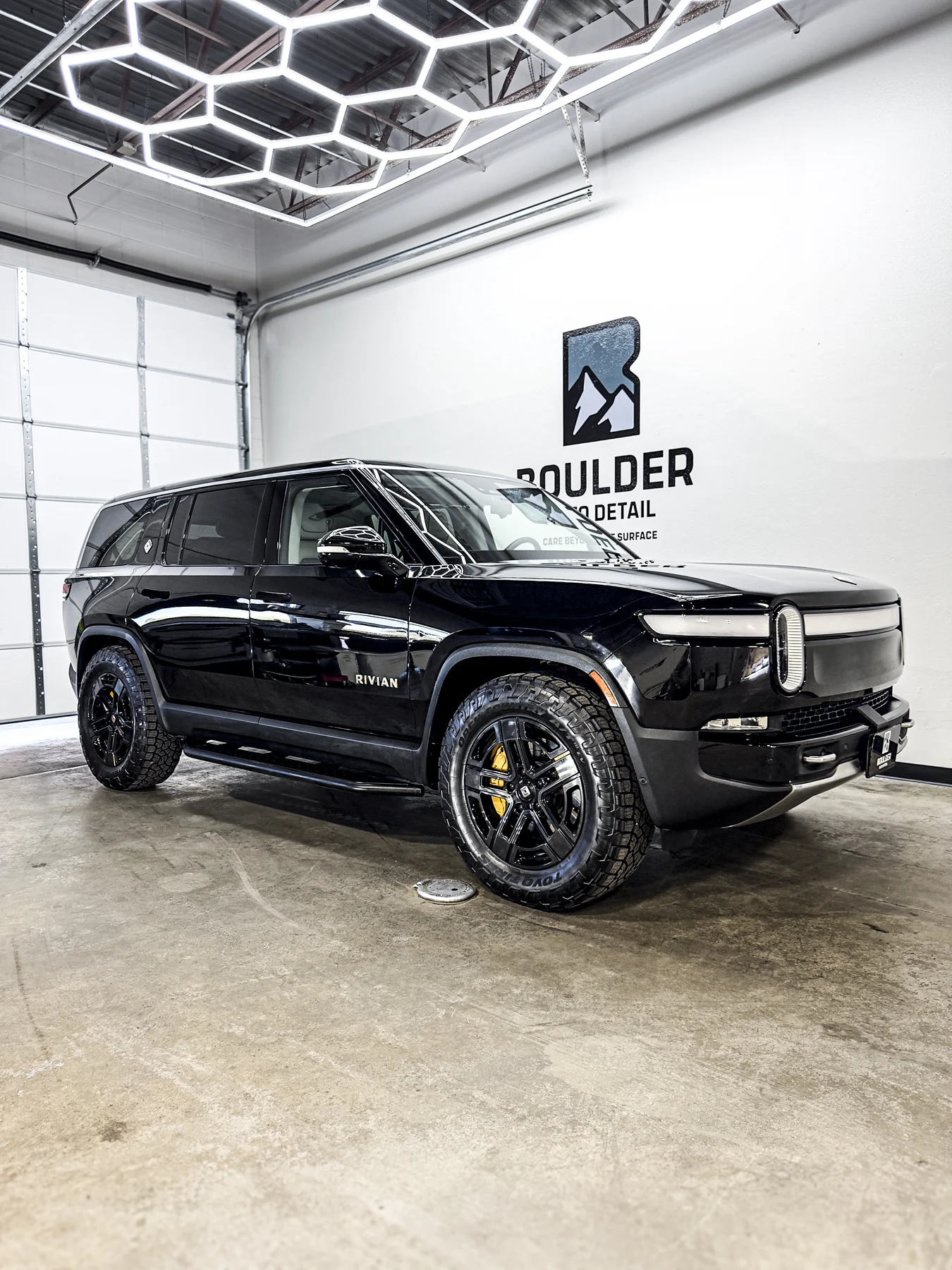 Black SUV photographed inside Boulder Auto Detail