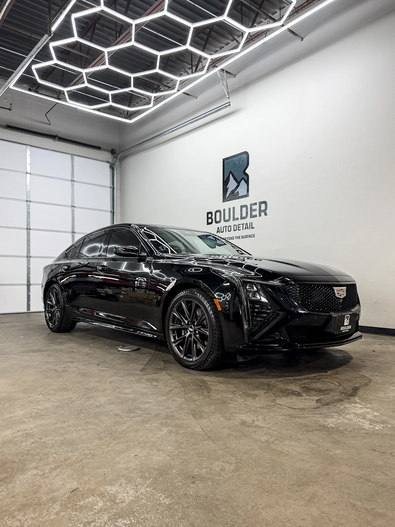 Dark luxury sedan photographed inside Boulder Auto Detail