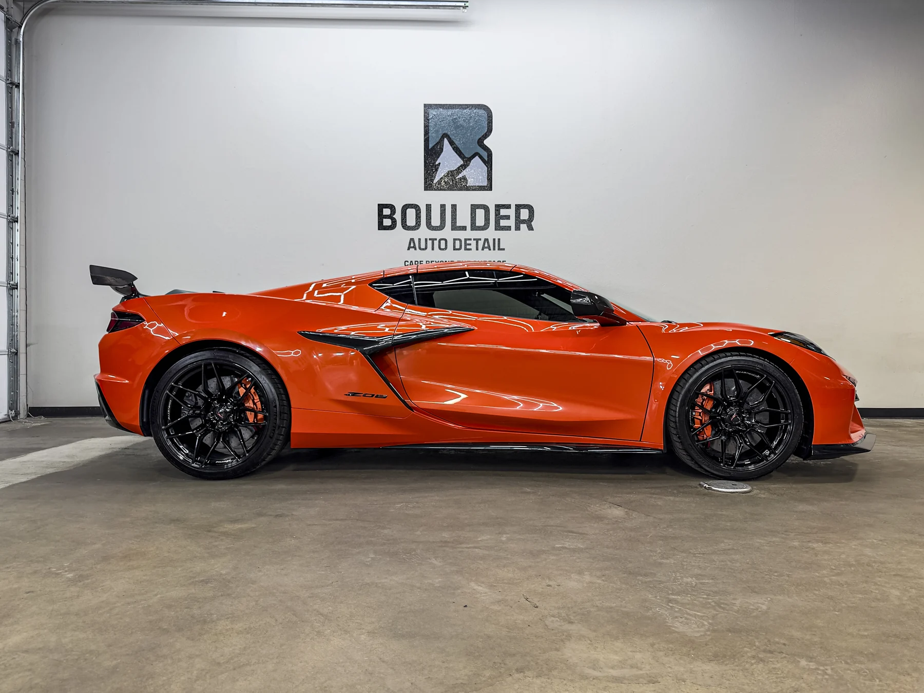 Orange Chevrolet Corvette photographed inside Boulder Auto Detail