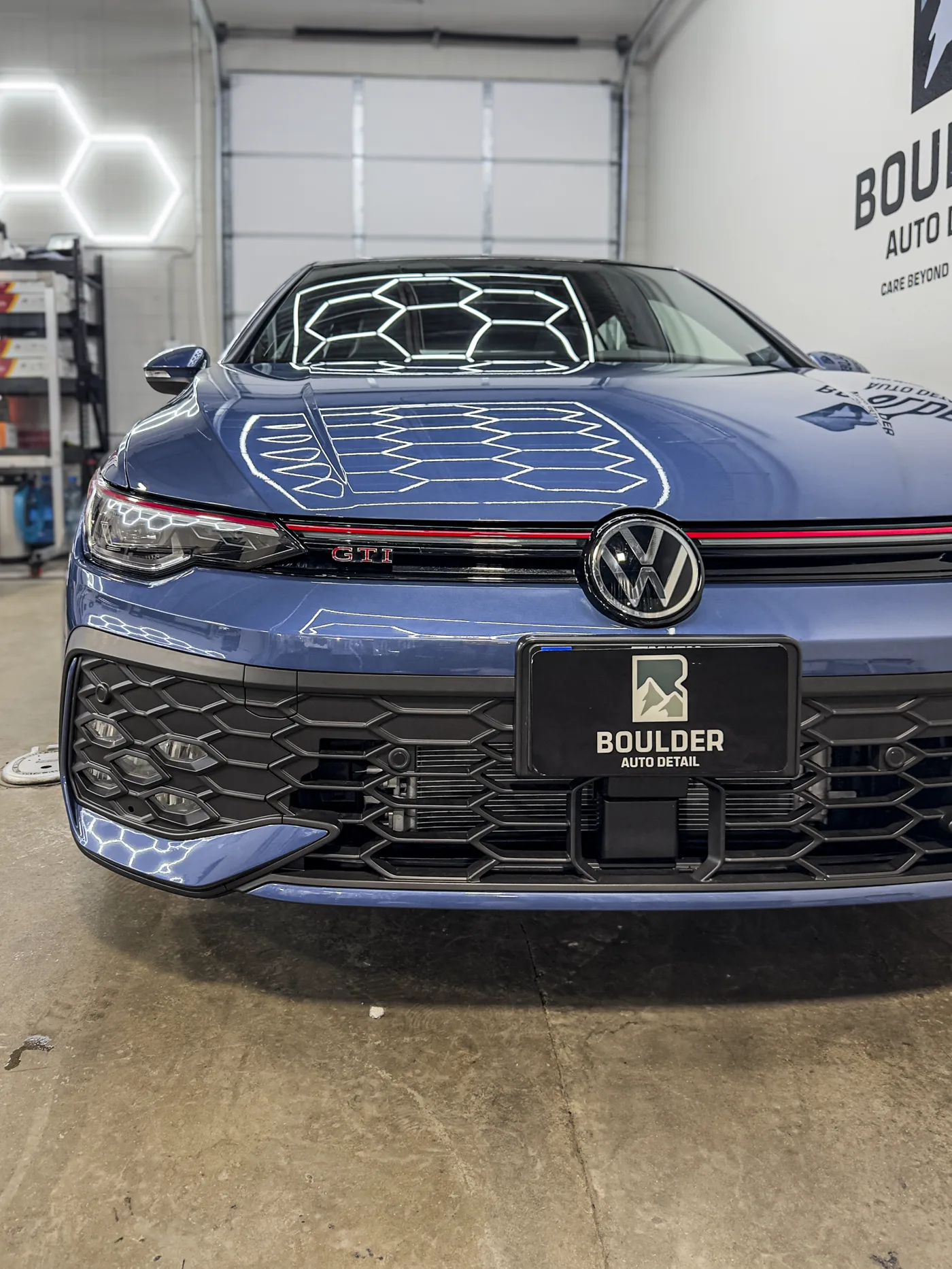 Vehicle paint inspected under detailing lights at Boulder Auto Detail
