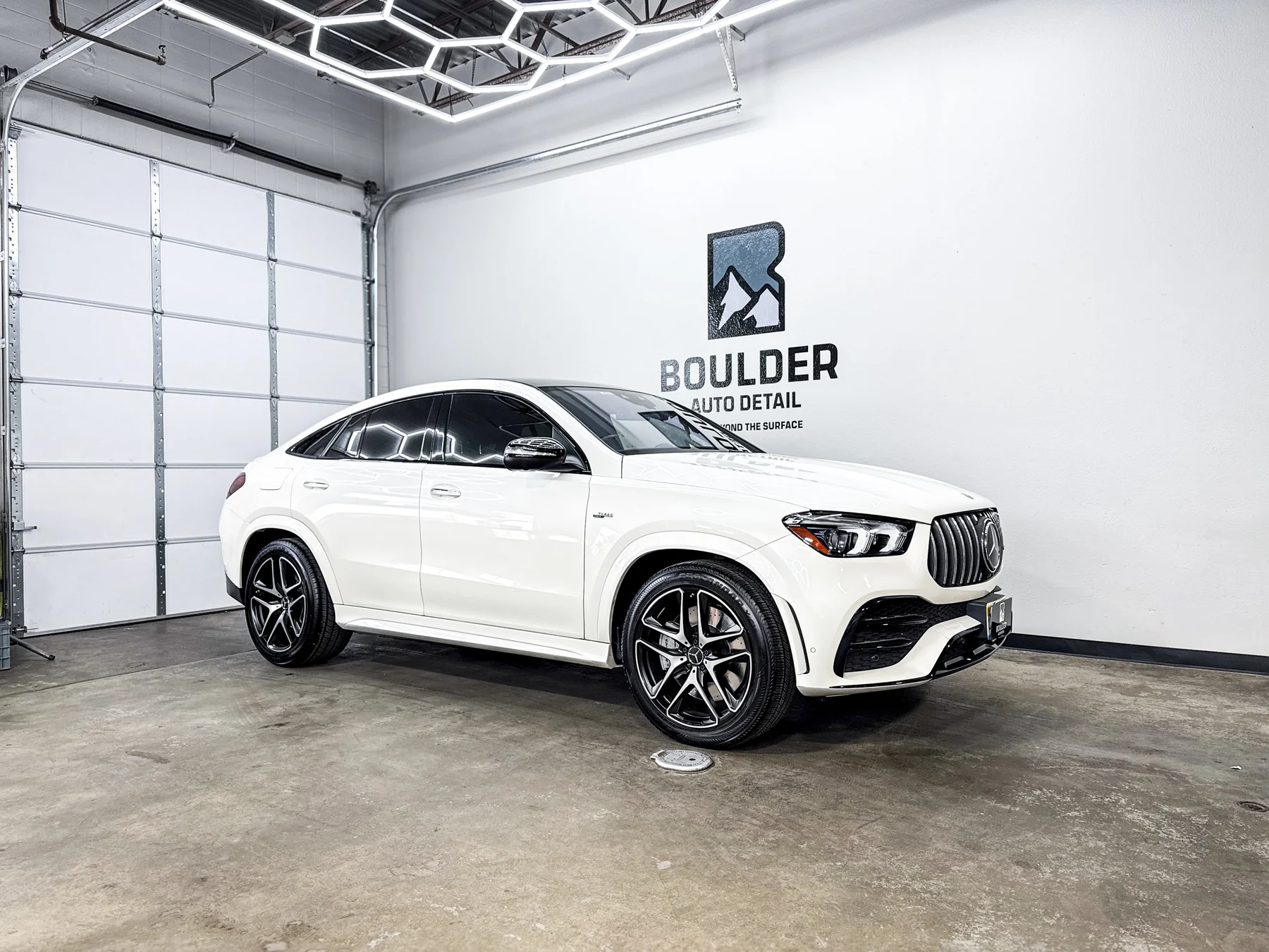 White luxury SUV photographed inside Boulder Auto Detail