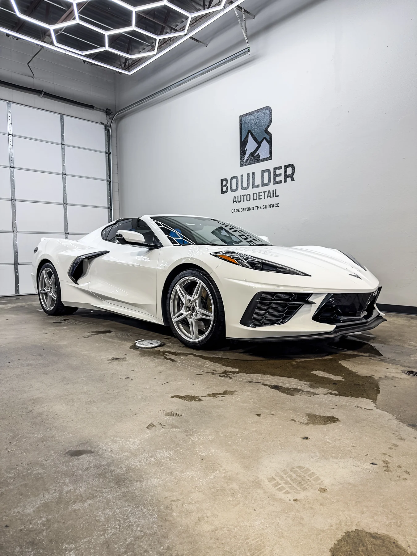 White Chevrolet Corvette photographed inside Boulder Auto Detail