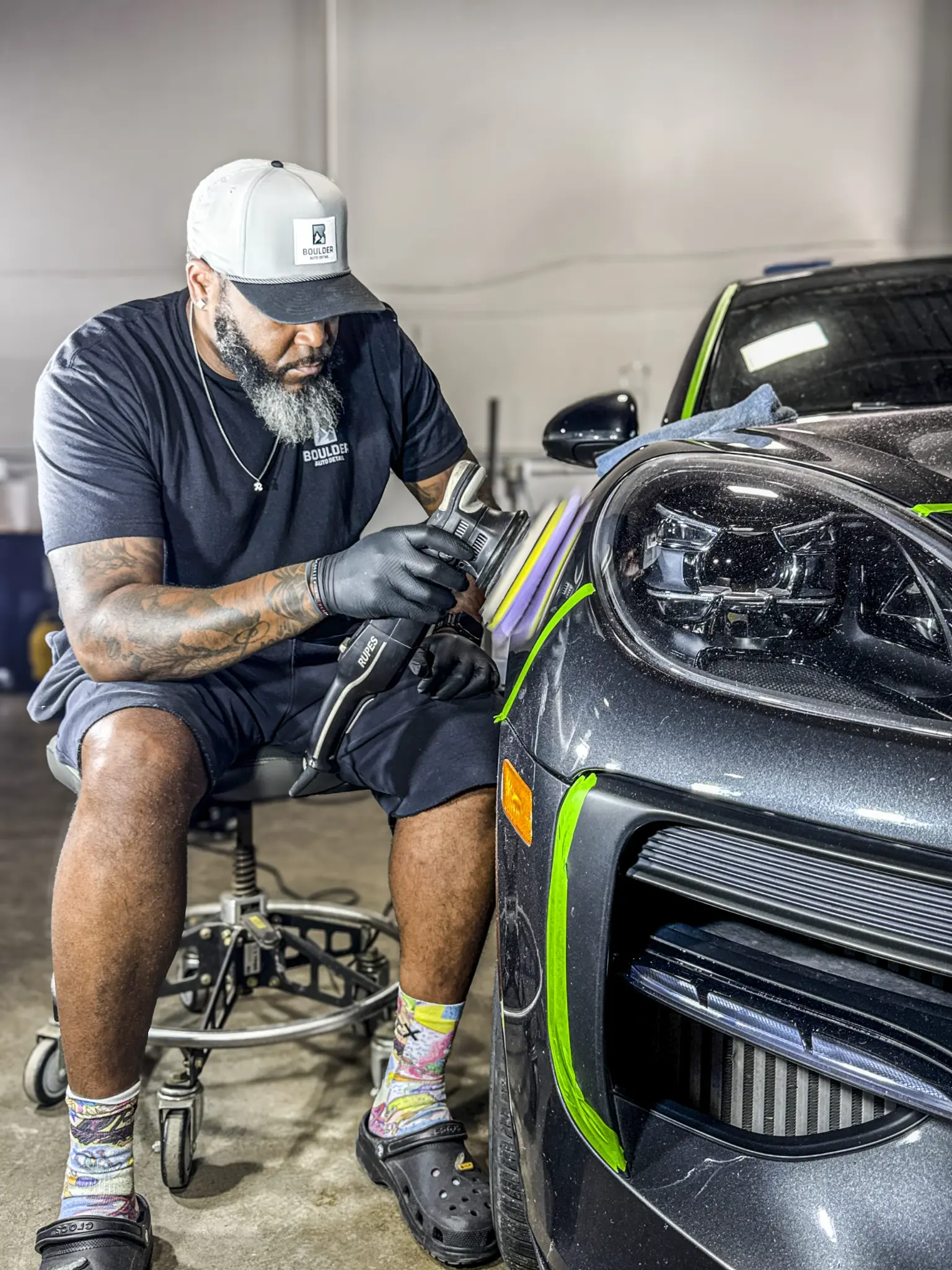 Reggie polishing a vehicle front panel at Boulder Auto Detail